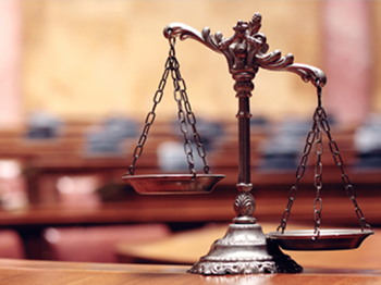 Image of a scales of justice in a court room 