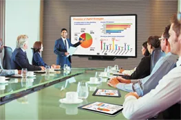 Doctor sitting in front of a computer displaying a video of a patient
