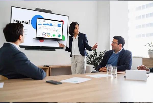 3 office people having a meeting with a display on the wall