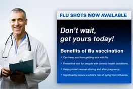 Doctor standing next to a commercial display showing how digital signage can help dispense medical information