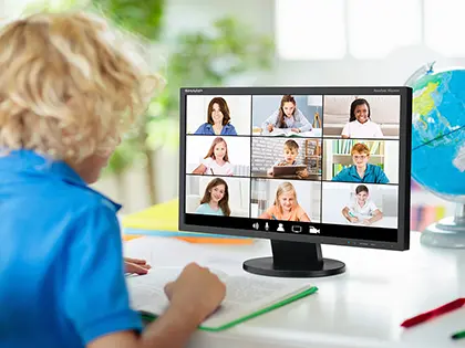 Desktop display with a teacher doing online classes