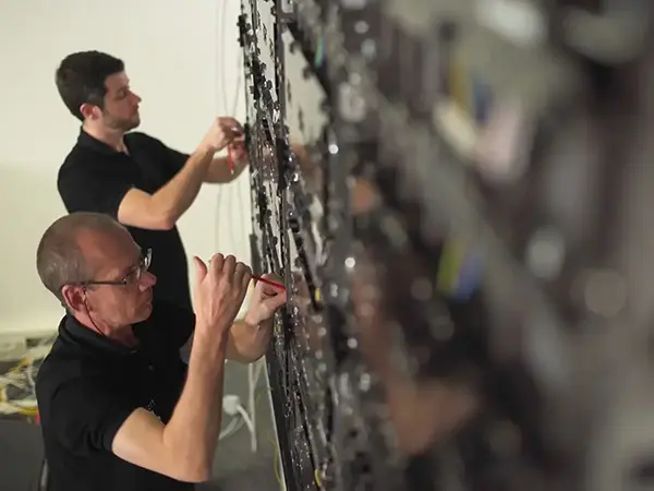 Two men installing an LED display