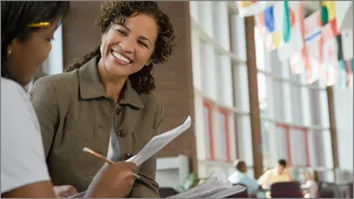 Image of 2 women in an office speaking
