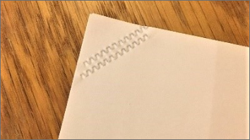 Image of paper with crimped corners using stapleless printing instead of staples
