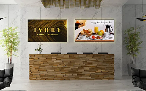 Lobby reception desk with 2 diplays on the wall behind