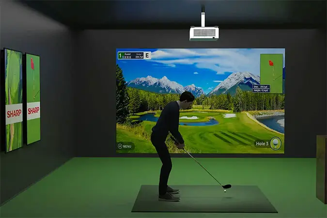 Laser projector mounted on the ceiling being used for golf simulation