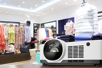 A laser projector on a table in a clothing retail store