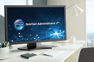 A computer monitor displaying the NaViSet Administrator 2 software interface on a modern desk.