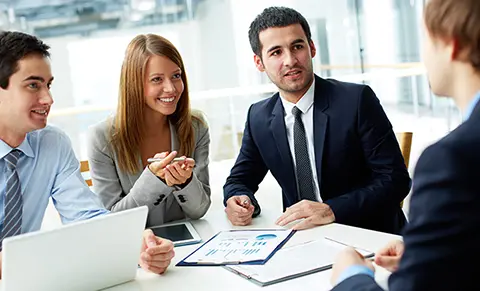 Four people sitting around a table in a discussion