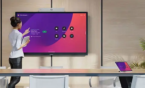Woman using the Cisco app on a large screen display