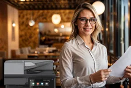 Two women standing in front of a copier