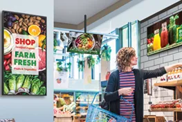 Woman shopping in store with digital displays on the walls