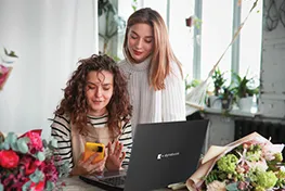 Two women looking at a Dynabook laptop