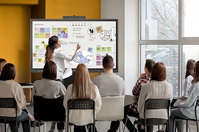 Classroom of students at their desks with a projector in the front