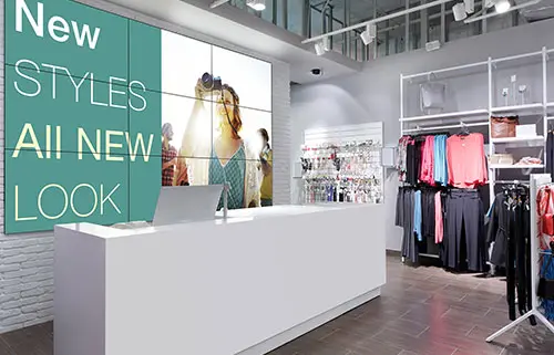 Video wall displaying promotions behind the cash register in a retail store